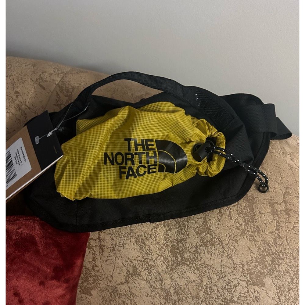 The North Face waist pack extra draw string pocket on bag, water proof material